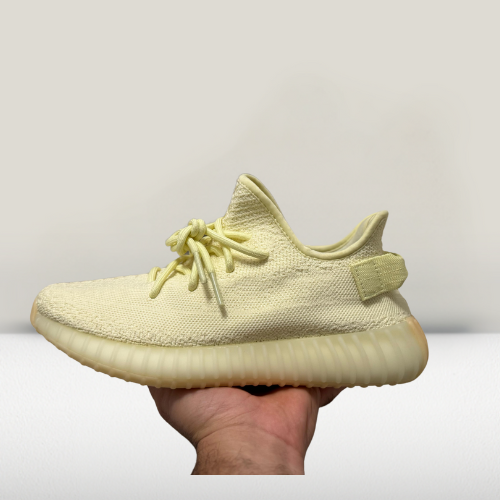 Side profile of Yeezy 350 V2 Cream White shoes showcasing Primeknit upper and BOOST midsole technology